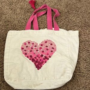 Cream colored bag with pink sparkle heart
